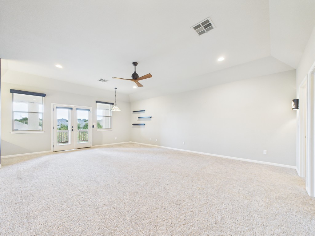 2624 Outlook Ridge Loop Leander, TX 78641 - Photo 29 of 39 an empty room with chandelier fan and windows