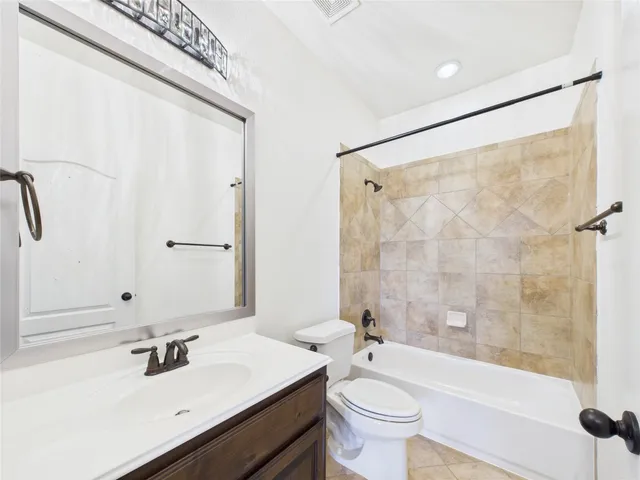 a bathroom with a sink mirror toilet and bathtub