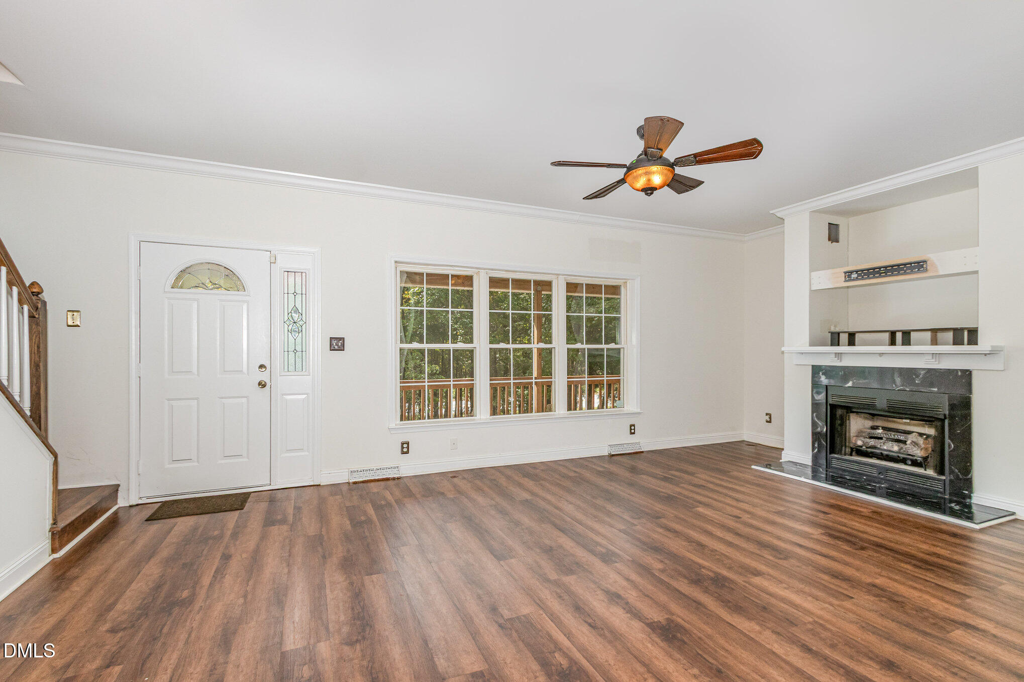 1176 Stoney Mountain Road Rougemont, NC 27572 - Photo 11 of 44 an empty room with windows fireplace and wooden floor