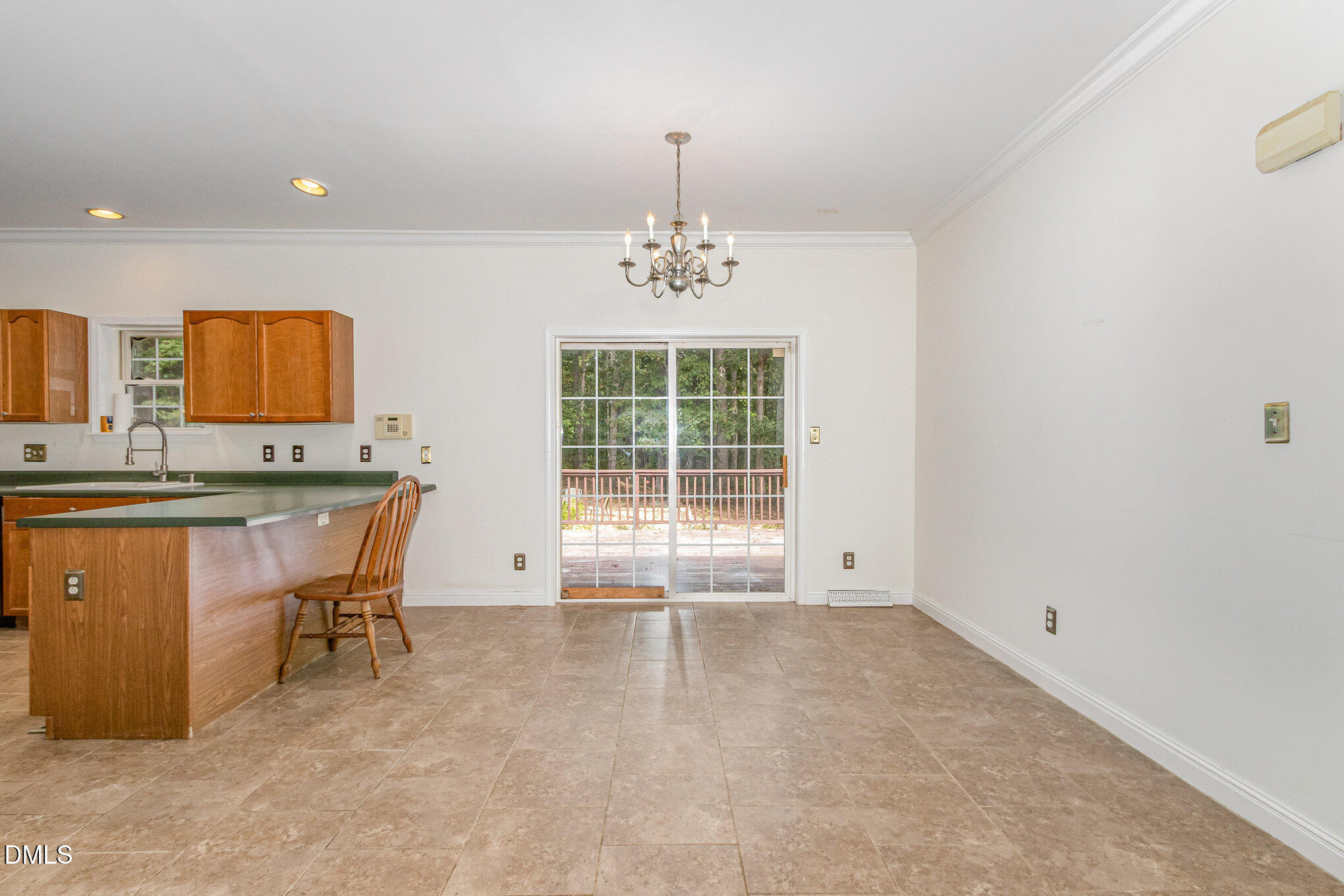 1176 Stoney Mountain Road Rougemont, NC 27572 - Photo 16 of 44 a view of a kitchen with kitchen island a sink wooden floor and a window