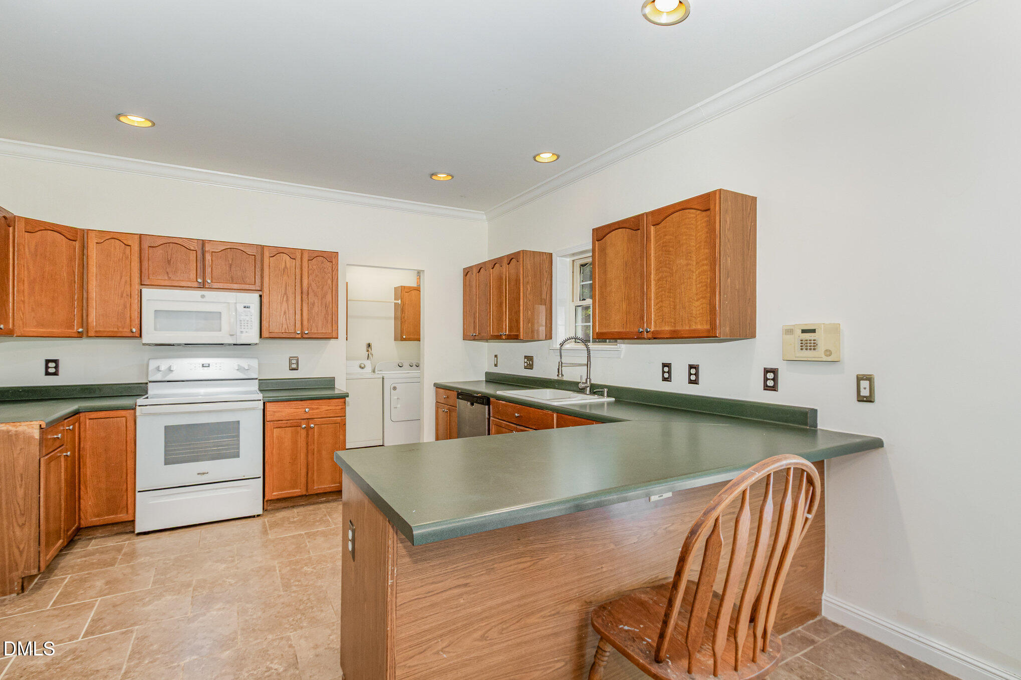1176 Stoney Mountain Road Rougemont, NC 27572 - Photo 17 of 44 a kitchen with stainless steel appliances granite countertop a stove a sink and a microwave