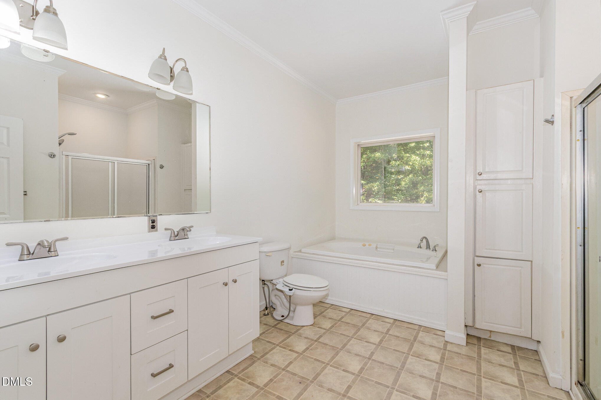 1176 Stoney Mountain Road Rougemont, NC 27572 - Photo 25 of 44 a bathroom with a double vanity sink a toilet and a bathtub