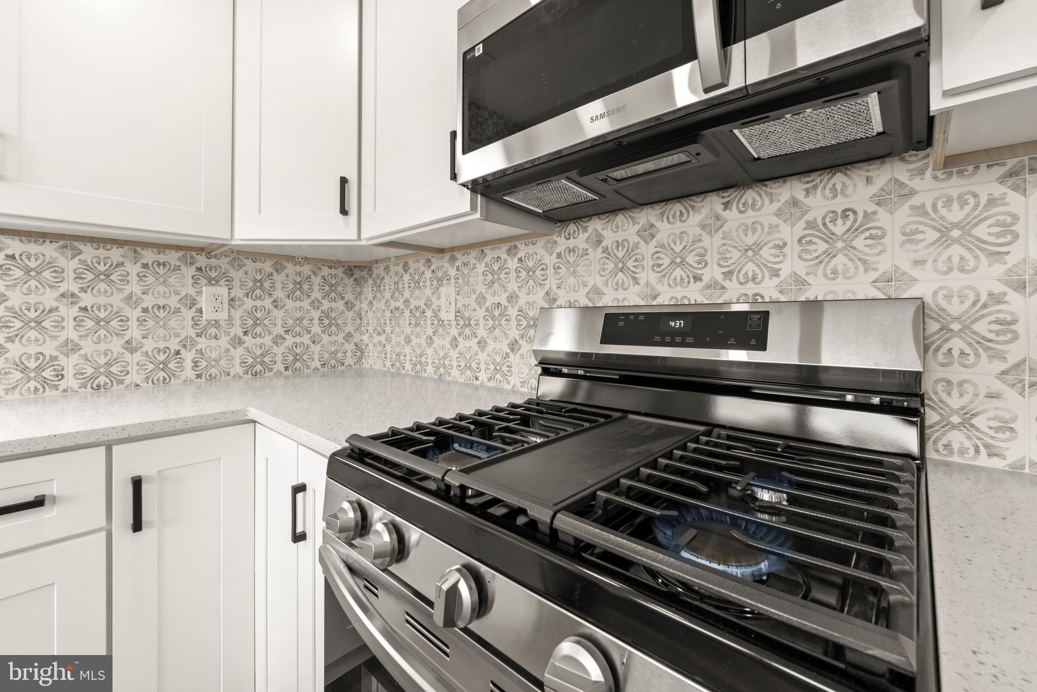 23 Hastings Road Hamilton, NJ 08620 - Photo 11 of 35 a stove top oven sitting inside of a kitchen