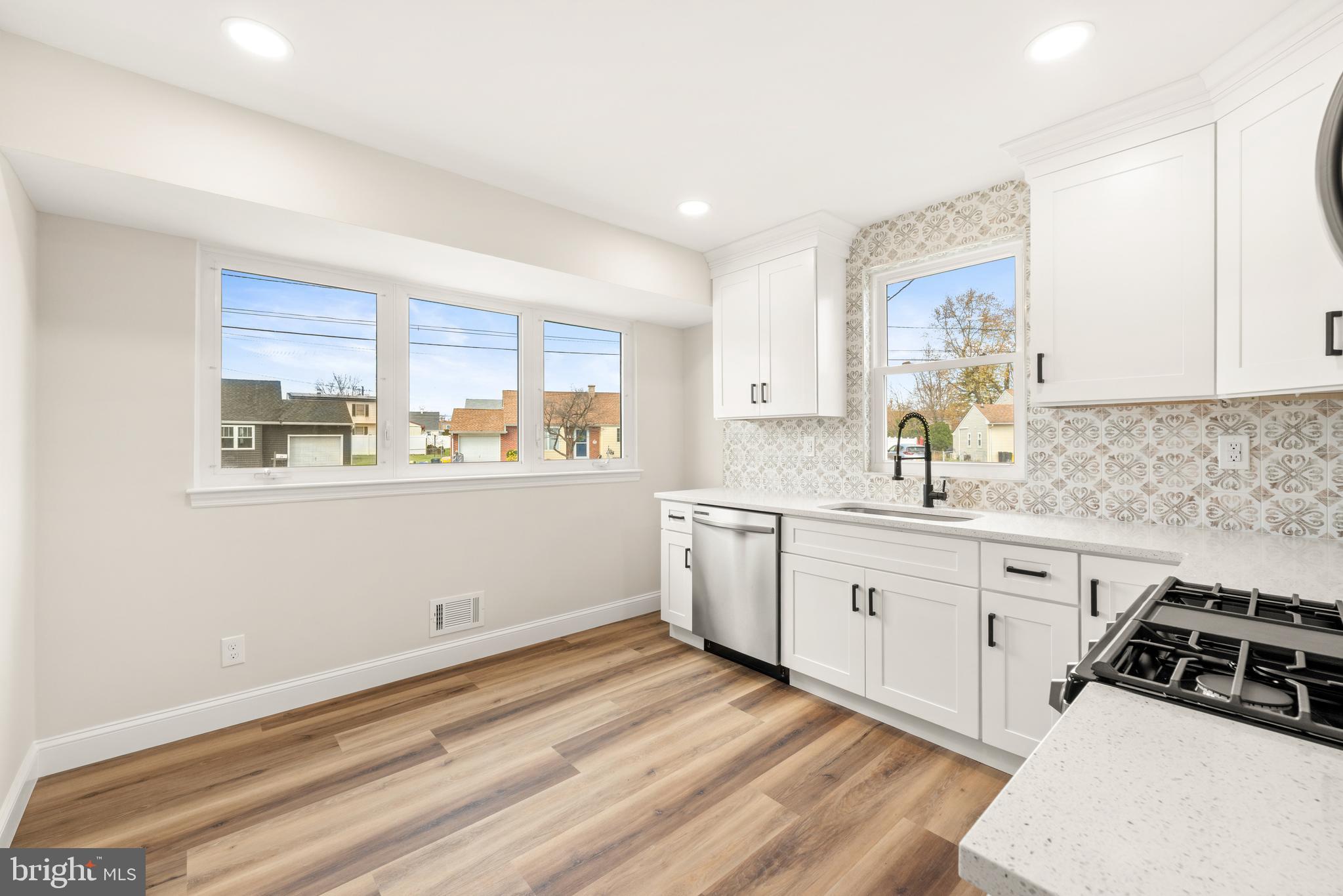 23 Hastings Road Hamilton, NJ 08620 - Photo 12 of 35 a kitchen with granite countertop white cabinets and white appliances