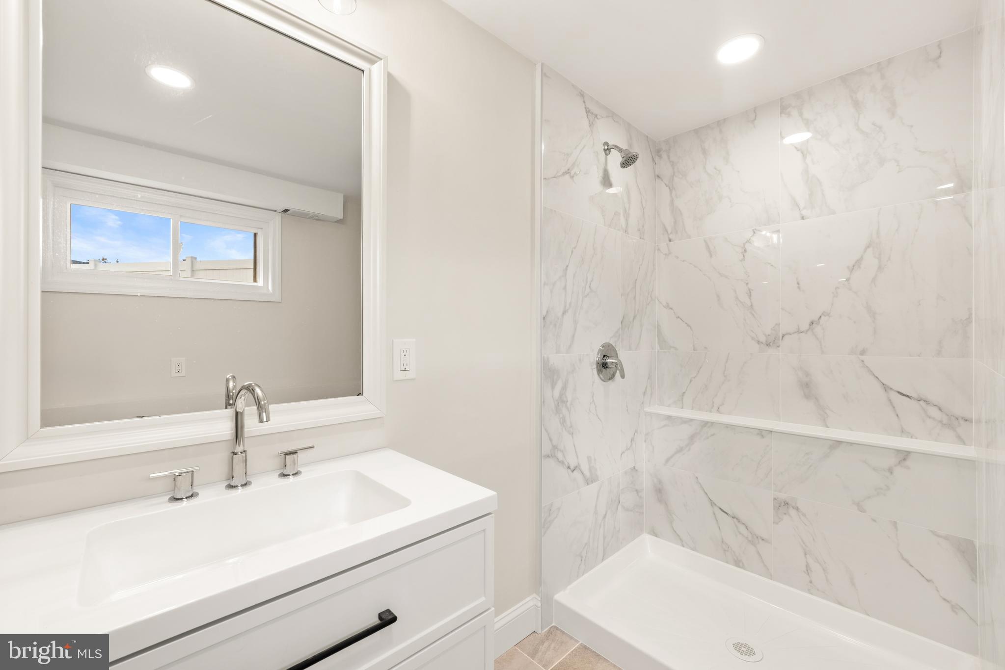 23 Hastings Road Hamilton, NJ 08620 - Photo 31 of 35 a bathroom with a sink a toilet and shower