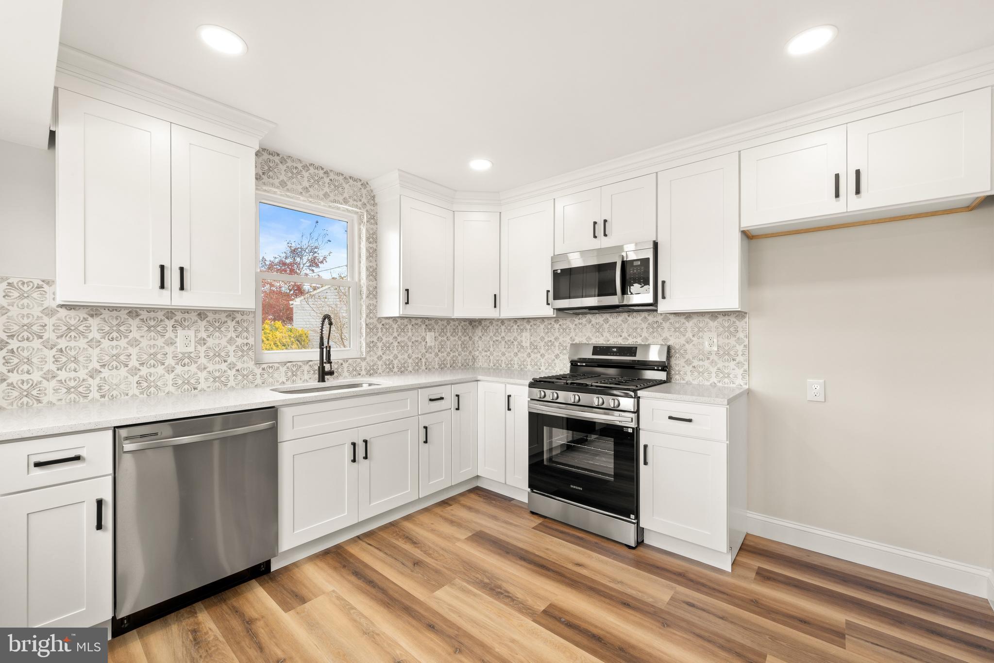 23 Hastings Road Hamilton, NJ 08620 - Photo 10 of 35 a kitchen with granite countertop white cabinets and stainless steel appliances
