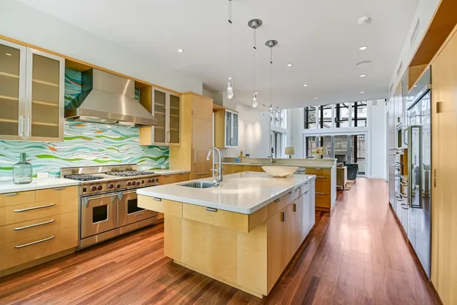 a large kitchen with stainless steel appliances and a stove
