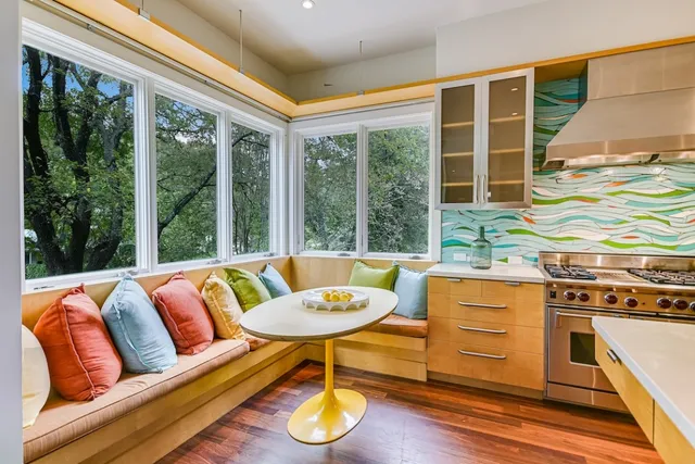 a living room with furniture and a floor to ceiling window