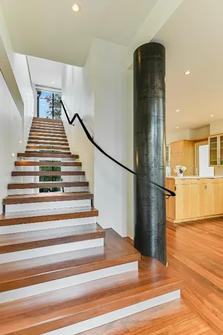a view of entryway and hall with wooden floor