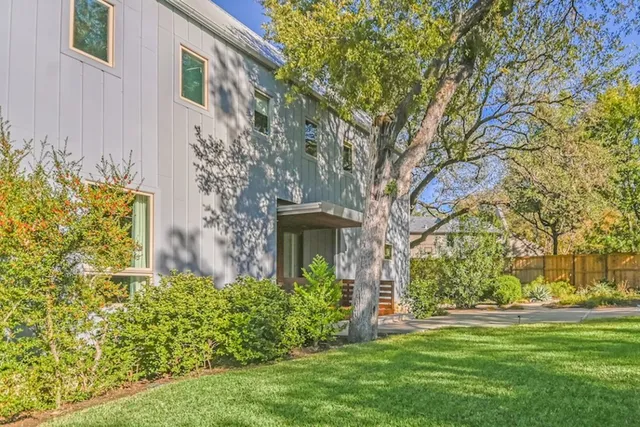 a front view of a house with a garden