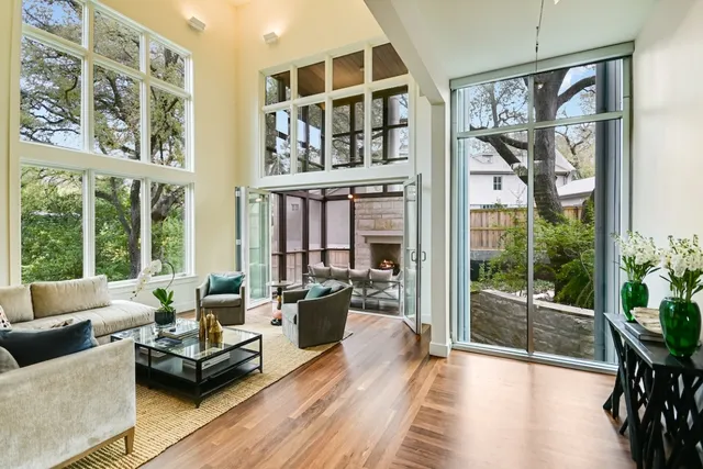 a living room with furniture and a floor to ceiling window