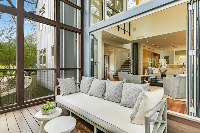 a living room with furniture and a floor to ceiling window
