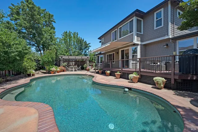 a view of a patio with swimming pool table and chairs