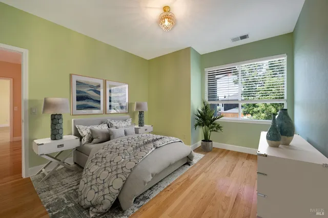 a bedroom with a bed and a potted plant