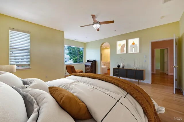 a bedroom with a large bed and a chandelier