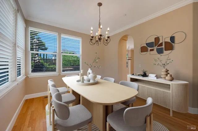 a view of a dining room with furniture window and wooden floor
