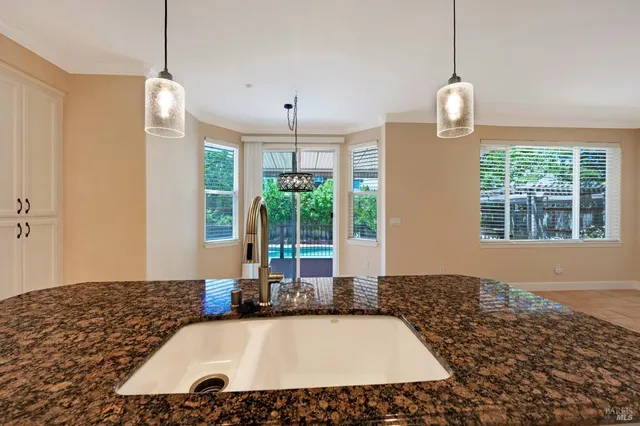 a room with pool table and windows