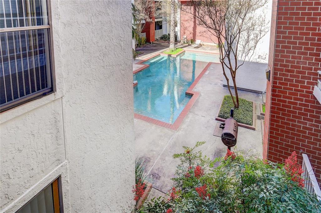 3115 Helms Street, Unit 204 Austin, TX 78705 - Photo 10 of 13 An inviting courtyard with a shimmering pool offers a tranquil escape.