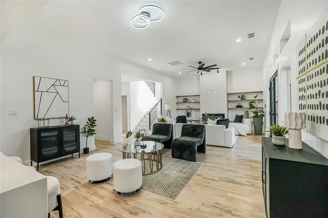 a living room with furniture kitchen view and a fireplace