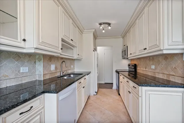 a kitchen with granite countertop a sink and cabinets