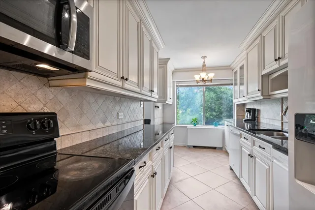 a kitchen with stainless steel appliances granite countertop a sink and a stove