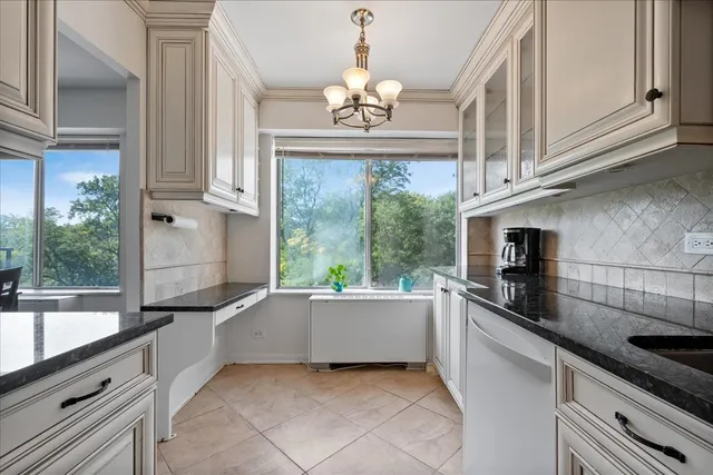 a kitchen with granite countertop a sink and a stove