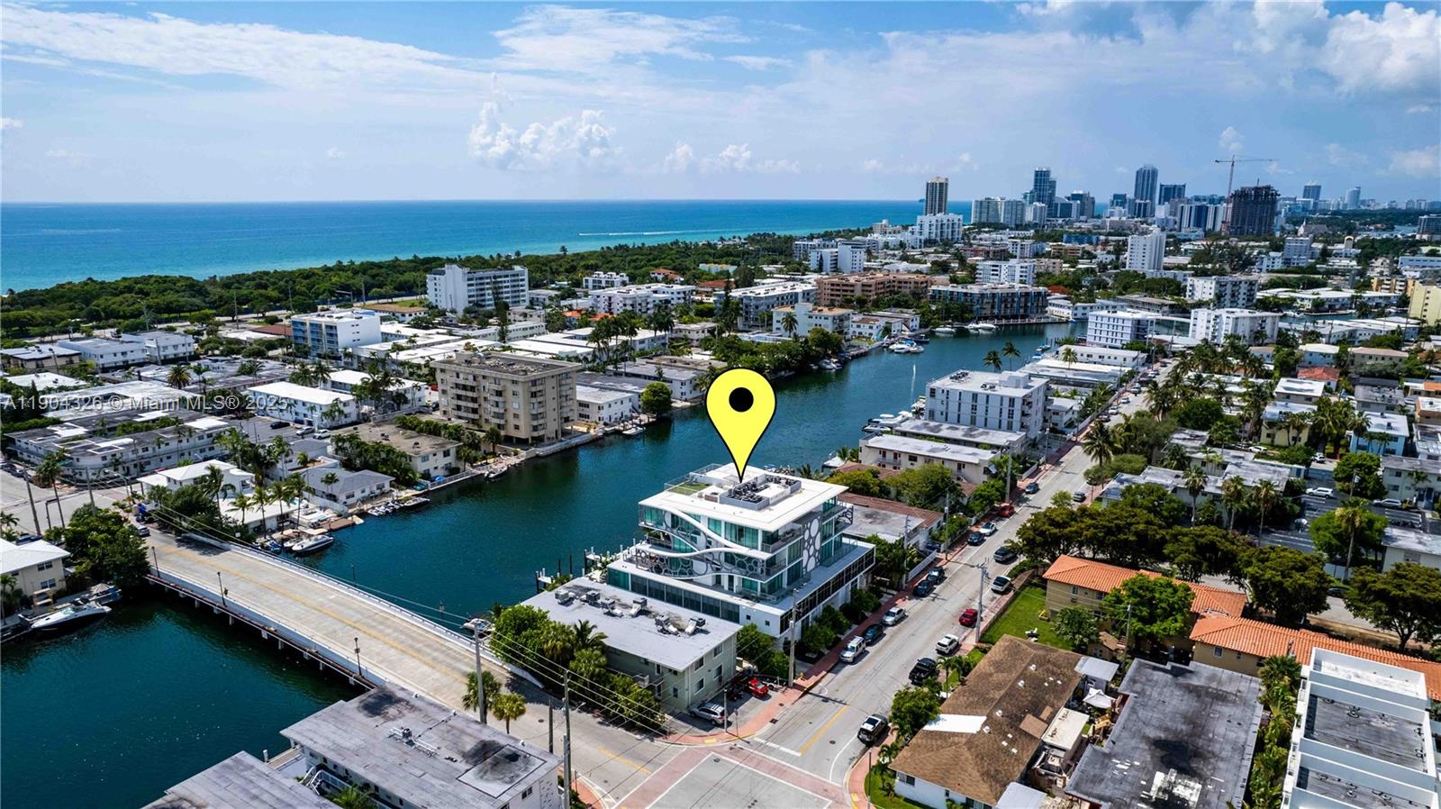 8425 Crespi Boulevard, Unit 404 Miami Beach, FL 33141 - Photo 21 of 21 an aerial view of a city with lots of residential buildings ocean and mountain view in back