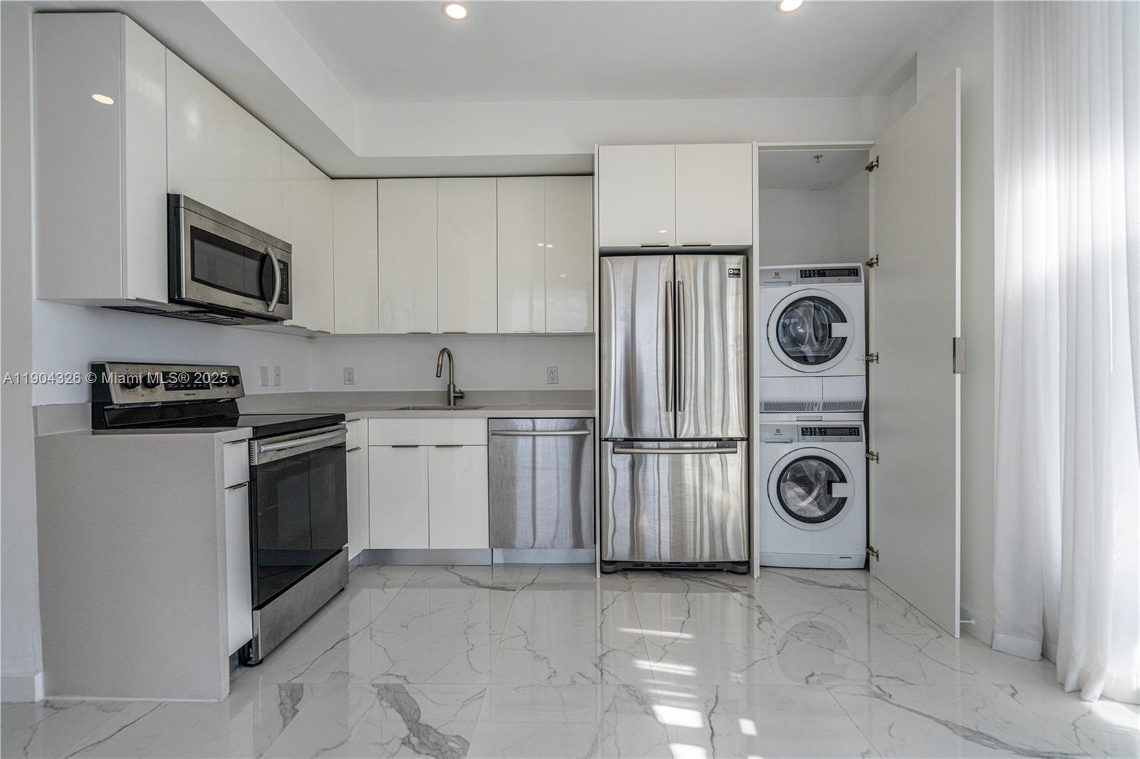 8425 Crespi Boulevard, Unit 404 Miami Beach, FL 33141 - Photo 8 of 21 a kitchen with a stove top oven and refrigerator