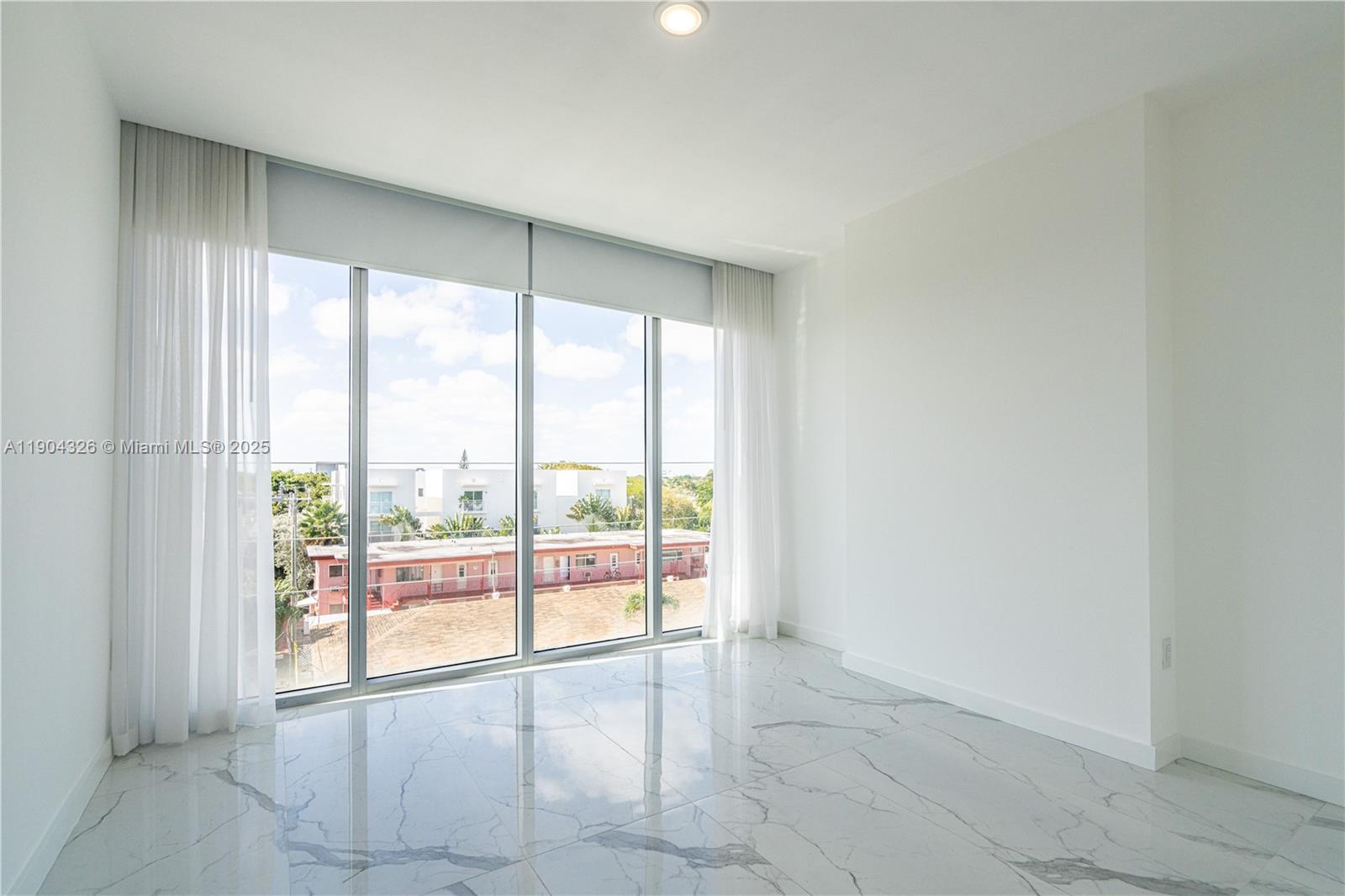 8425 Crespi Boulevard, Unit 404 Miami Beach, FL 33141 - Photo 9 of 21 a view of an empty room and window