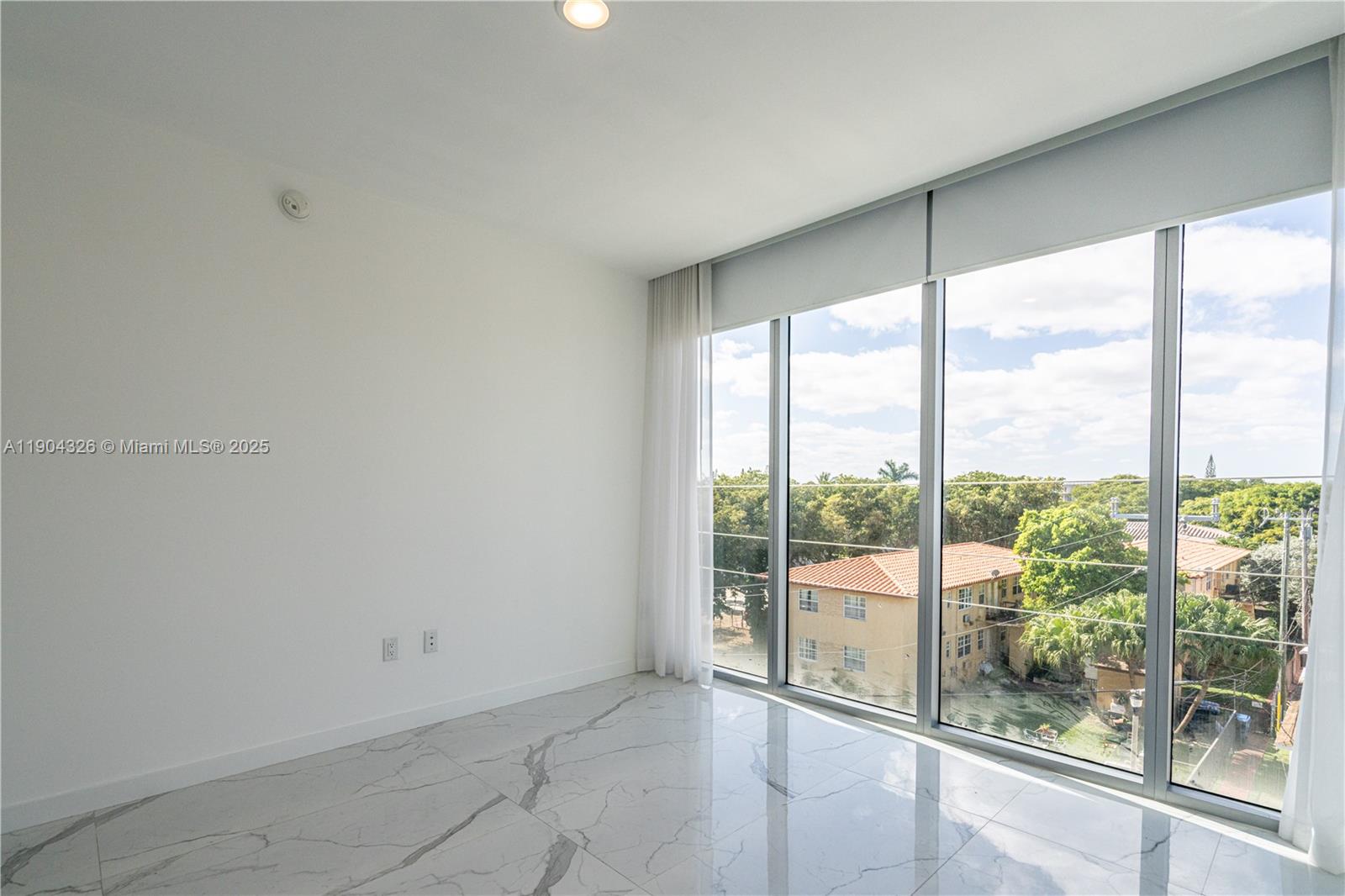 8425 Crespi Boulevard, Unit 404 Miami Beach, FL 33141 - Photo 10 of 21 a view of an empty room and window