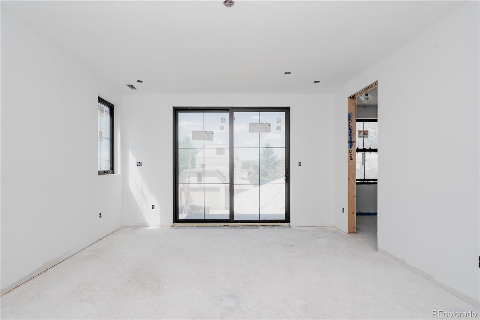 1935 Meade Street Denver, CO 80204 - Photo 12 of 43 an empty room with closet and windows