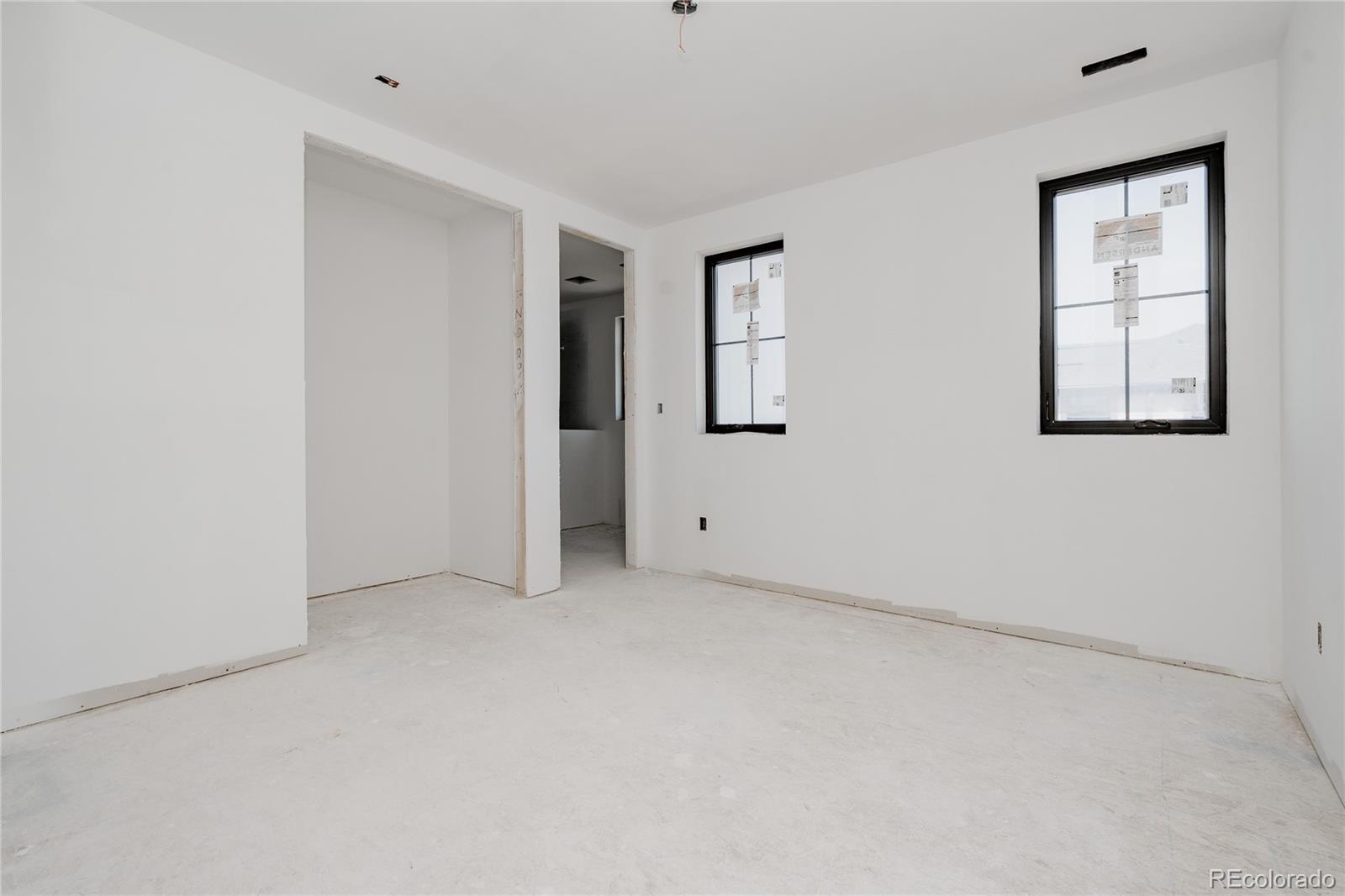 1935 Meade Street Denver, CO 80204 - Photo 19 of 43 an empty room with windows and closet
