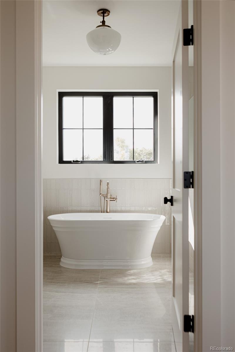1935 Meade Street Denver, CO 80204 - Photo 39 of 43 a bath tub sitting next to a window