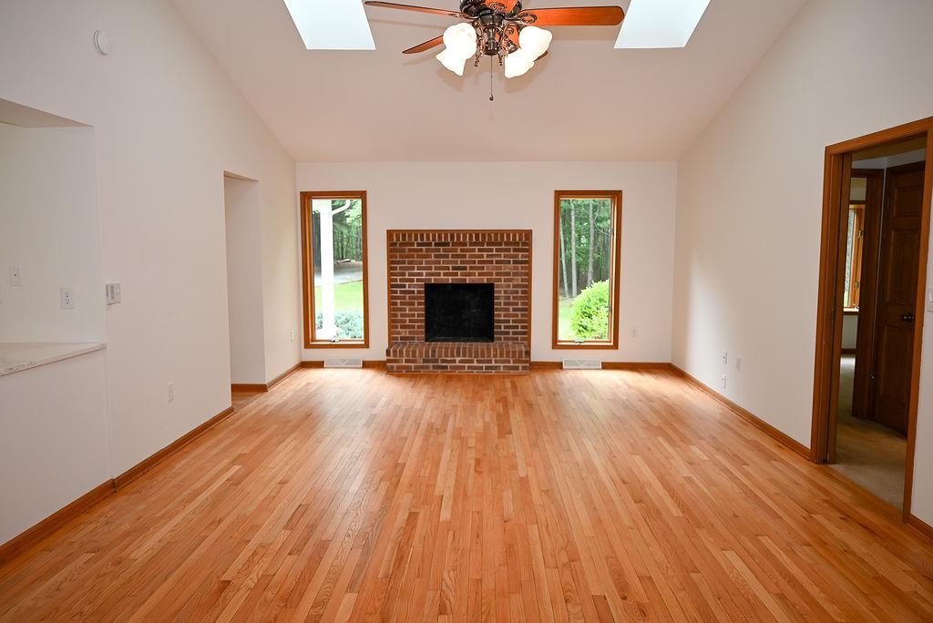 5662 Sugar Ridge Road Crozet, VA 22932 - Photo 12 of 49 wooden floor fireplace and windows in an empty room
