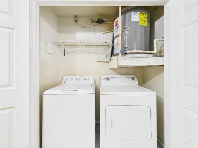 an empty room with windows and ceiling fan