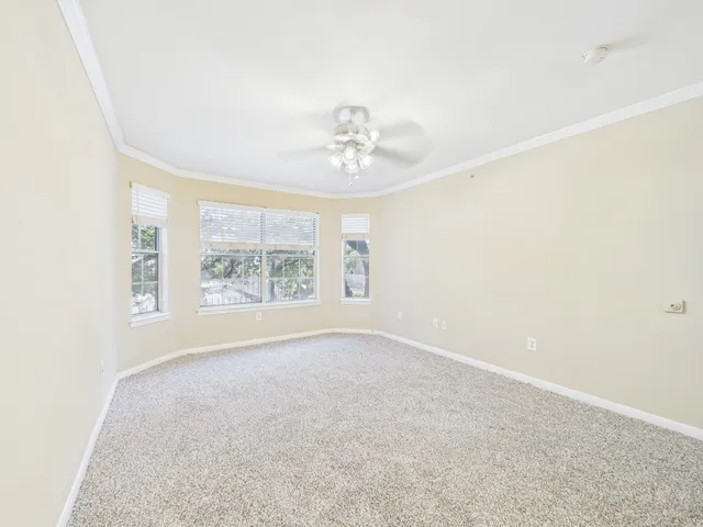 a view of an empty room with a ceiling fan