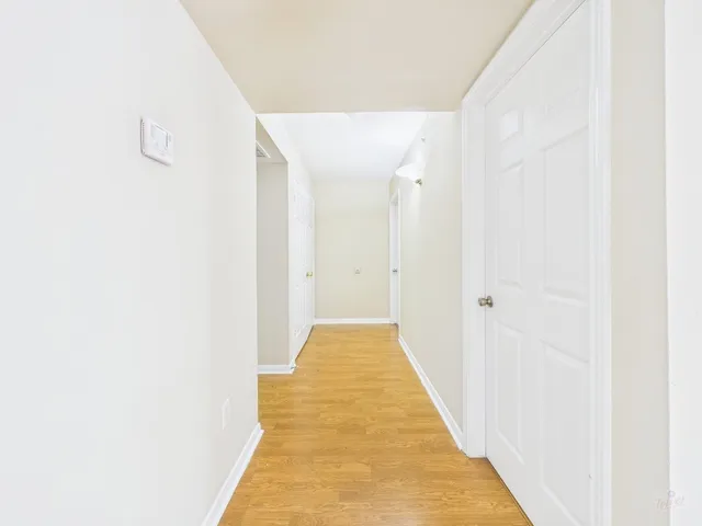 a view of hallway with wooden floor