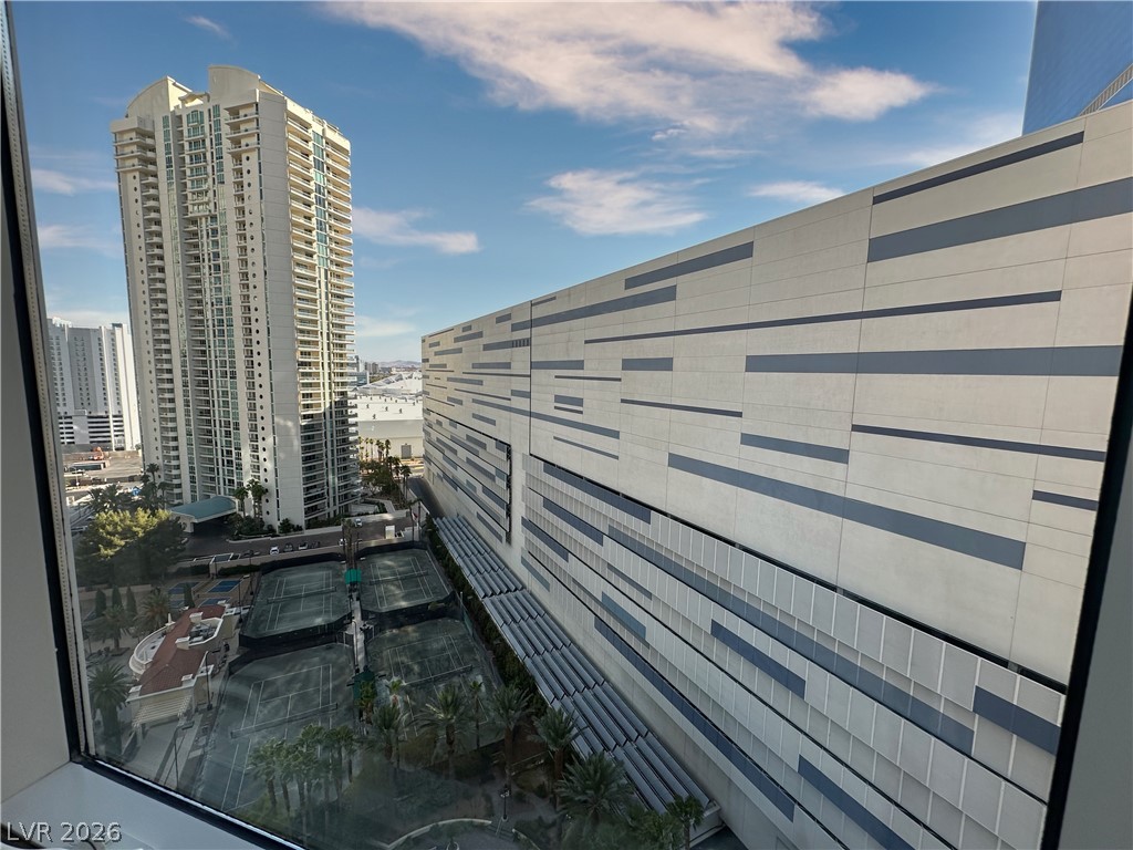 2747 Paradise Road, Unit 1706 Las Vegas, NV 89109 - Photo 24 of 35 Cityscape views from a window, featuring high-rise architecture and recreational amenities below.