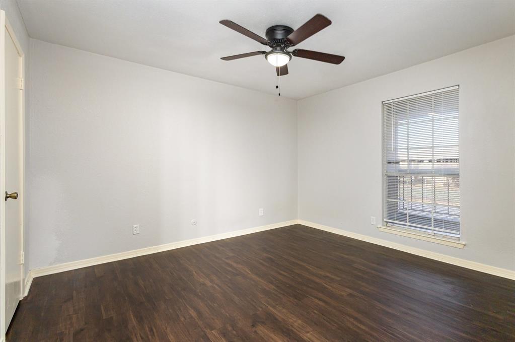 12480 Abrams Road, Unit 723 Dallas, TX 75243 - Photo 13 of 19 an empty room with wooden floor and windows