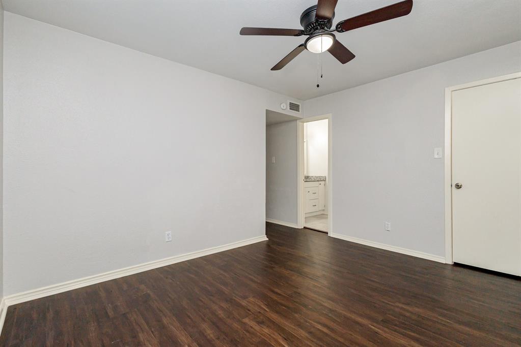 12480 Abrams Road, Unit 723 Dallas, TX 75243 - Photo 14 of 19 an empty room with wooden floor ceiling fan and windows