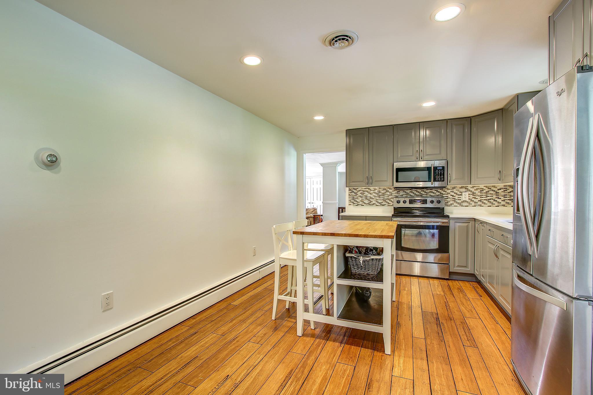 13846 Penn Shop Road Mount Airy, MD 21771 - Photo 11 of 42 a kitchen with a refrigerator and a stove top oven
