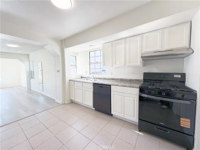a kitchen with a stove top oven sink and cabinets