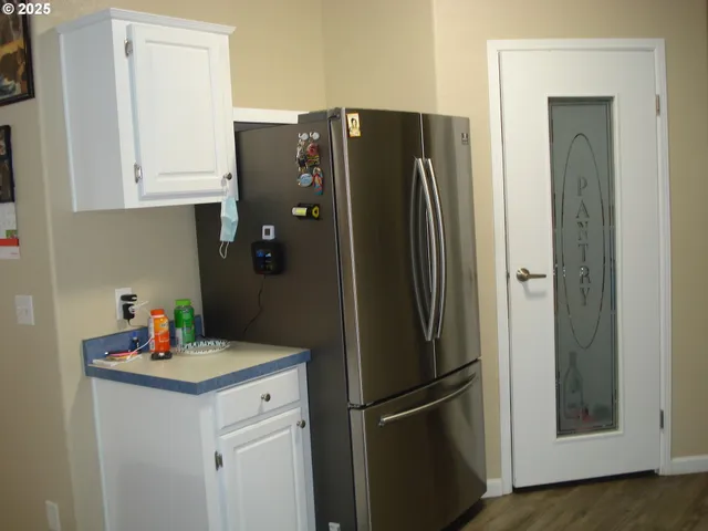 a kitchen with stainless steel appliances a refrigerator and cabinets