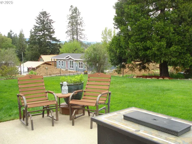 a view of a chairs and table in the garden