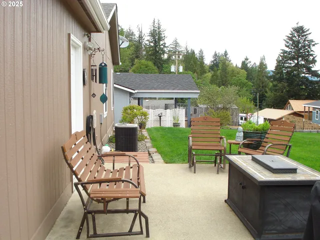 a view of a chairs and table in backyard of the house