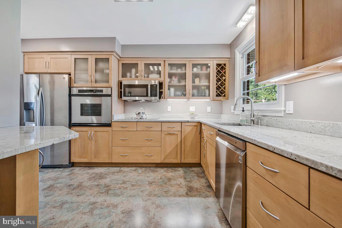 5811 Ridgefield Road Bethesda, MD 20816 - Photo 13 of 33 a kitchen with stainless steel appliances granite countertop a refrigerator and stove