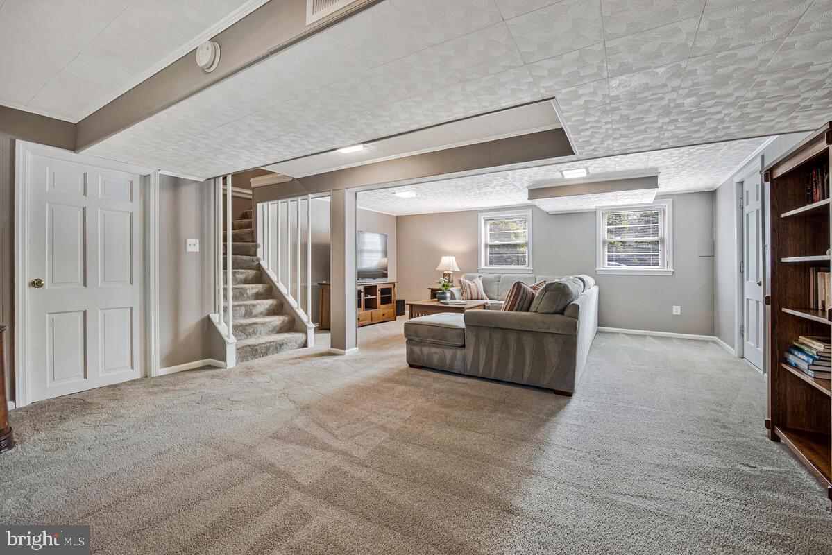 5811 Ridgefield Road Bethesda, MD 20816 - Photo 28 of 33 a living room with furniture and a flat screen tv