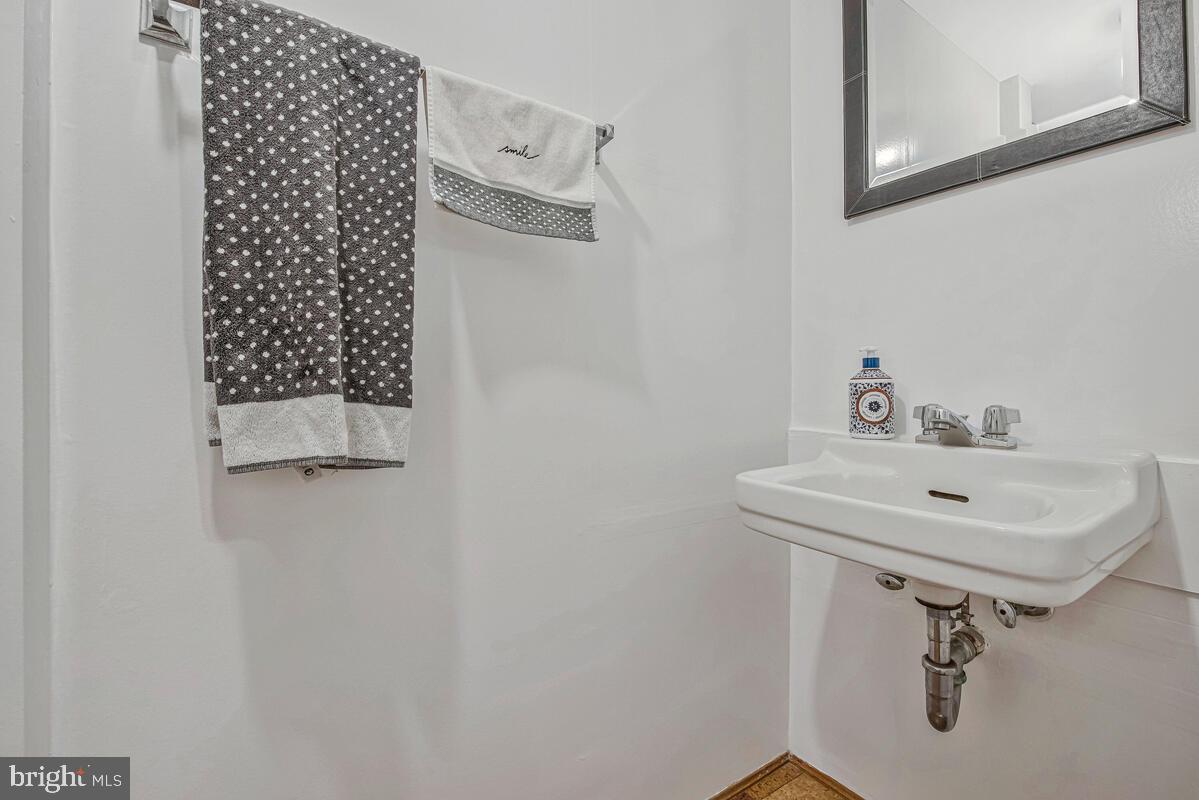 5811 Ridgefield Road Bethesda, MD 20816 - Photo 30 of 33 a bathroom with a sink a mirror and a toilet