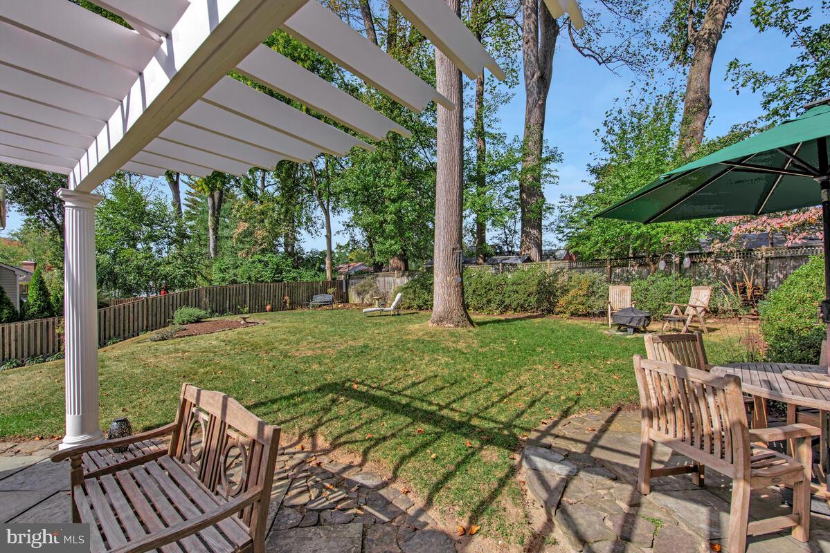 5811 Ridgefield Road Bethesda, MD 20816 - Photo 4 of 33 a view of a patio with a table chairs and a backyard