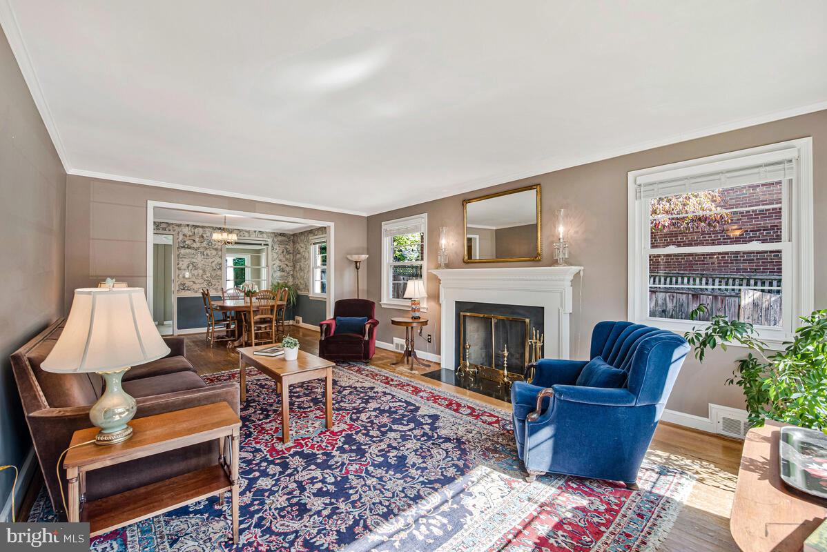 5811 Ridgefield Road Bethesda, MD 20816 - Photo 8 of 33 a living room with furniture large window and a fireplace